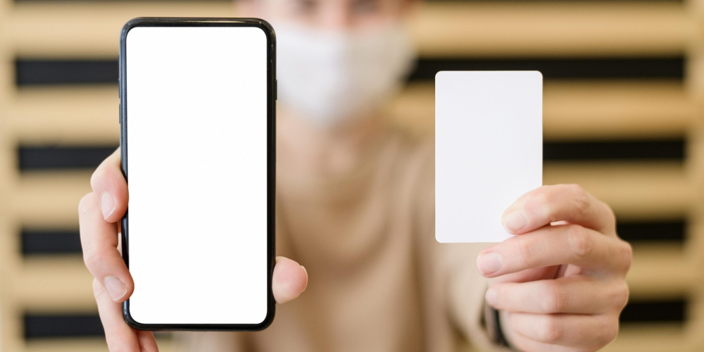 close-up-woman-holding-mobile-phone-card